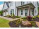 Well-manicured front yard with beautifully landscaped flower beds, rock features, and a brick and wood home at 1011 Ridgeview Rd, Woodstock, GA 30188