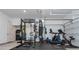 A well-equipped home gym in the garage featuring a punching bag, treadmill, and weight rack at 1011 Ridgeview Rd, Woodstock, GA 30188