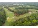 Panoramic aerial view of a scenic golf course surrounded by lush forests and greenery at 1011 Ridgeview Rd, Woodstock, GA 30188