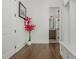 Hallway showcases hardwood floors, a decorative red tree, and a view of the bathroom at 1011 Ridgeview Rd, Woodstock, GA 30188