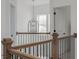 Upstairs hallway features a decorative light fixture and wood and black metal bannister at 1011 Ridgeview Rd, Woodstock, GA 30188