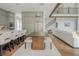 Open concept kitchen flowing into dining and living areas, featuring stainless appliances and modern fixtures at 1011 Ridgeview Rd, Woodstock, GA 30188