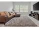 Cozy living room with a comfortable leather sofa and a large TV at 1011 Ridgeview Rd, Woodstock, GA 30188