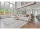 Bright living room with high ceilings, large windows, and a comfortable sofa at 1011 Ridgeview Rd, Woodstock, GA 30188