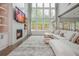 Bright living room with a fireplace, custom built-ins, oversized windows, and comfortable seating area at 1011 Ridgeview Rd, Woodstock, GA 30188
