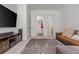 Living room with sofa, TV, and view of the bathroom at 1011 Ridgeview Rd, Woodstock, GA 30188