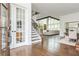 Open concept living room with staircase and dining area with hardwood floors at 1011 Ridgeview Rd, Woodstock, GA 30188