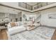 Open-concept living space featuring hardwood floors, a comfortable sofa, and a staircase to the second floor at 1011 Ridgeview Rd, Woodstock, GA 30188