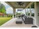 Covered patio with an outdoor kitchen, comfortable seating, and a view of the landscaped backyard at 1011 Ridgeview Rd, Woodstock, GA 30188