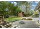 This backyard features an outbuilding, a fire pit, a stone retaining wall and beautiful surrounding greenery at 1245 Briar Hills Ne Dr, Atlanta, GA 30306