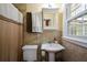 This is a quaint bathroom with a pedestal sink, medicine cabinet and ceramic tiling at 1245 Briar Hills Ne Dr, Atlanta, GA 30306