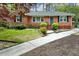 Charming brick home with a well-manicured front yard and a quaint blue front door at 1245 Briar Hills Ne Dr, Atlanta, GA 30306