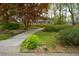Landscaped front yard with flowering trees and a walkway leading to a brick home at 1245 Briar Hills Ne Dr, Atlanta, GA 30306