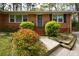 Classic brick home with neat landscaping, a blue door, and charming curb appeal at 1245 Briar Hills Ne Dr, Atlanta, GA 30306