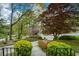 View from the porch of a well-maintained front yard with mature trees and flowering bushes at 1245 Briar Hills Ne Dr, Atlanta, GA 30306