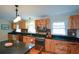 Charming kitchen featuring wood cabinets, black countertops, and a view into the backyard at 1245 Briar Hills Ne Dr, Atlanta, GA 30306