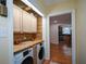 Bright laundry area with washer, dryer, counter space and wood cabinets at 1245 Briar Hills Ne Dr, Atlanta, GA 30306