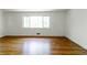 Spacious bedroom with hardwood floors and a large window providing natural light at 558 Larchmont Nw Dr, Atlanta, GA 30318