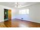 Bright bedroom with hardwood floors, a window, and easy access to an attached bathroom at 558 Larchmont Nw Dr, Atlanta, GA 30318