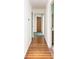 Long hallway with wooden floors leading to various rooms within the home at 558 Larchmont Nw Dr, Atlanta, GA 30318