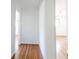 Bright hallway with wood floors leading to other rooms in the home at 558 Larchmont Nw Dr, Atlanta, GA 30318
