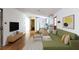 Bright living room boasts hardwood floors, modern decor, and ample space for relaxation and entertaining at 558 Larchmont Nw Dr, Atlanta, GA 30318