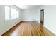 Large living room with hardwood floors, a big window and a view of the outdoor area at 558 Larchmont Nw Dr, Atlanta, GA 30318