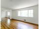 Bright and airy living room with hardwood floors and large windows offering serene views at 558 Larchmont Nw Dr, Atlanta, GA 30318