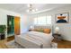 Bright main bedroom with a large bed and natural light from the window at 558 Larchmont Nw Dr, Atlanta, GA 30318