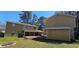 Extensive backyard with a red wood deck, lawn and the back of two buildings at 1406 High Sierra Dr, Lawrenceville, GA 30043