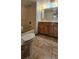 Classic bathroom featuring wood cabinetry, tile flooring, and tub-shower combination at 1406 High Sierra Dr, Lawrenceville, GA 30043