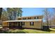 Charming two-story home with covered porch and yellow siding at 1406 High Sierra Dr, Lawrenceville, GA 30043
