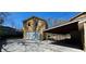 Back of the home featuring an attached garage, long driveway, and carport at 1406 High Sierra Dr, Lawrenceville, GA 30043