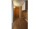 Narrow hallway featuring wood-look flooring and wall-mounted lighting at 1406 High Sierra Dr, Lawrenceville, GA 30043
