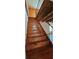 Wooden staircase with wooden beam ceiling and metal railing leading to the next level of the house at 1406 High Sierra Dr, Lawrenceville, GA 30043