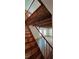 View of the wooden staircase with metal railing and exposed wooden ceiling beams at 1406 High Sierra Dr, Lawrenceville, GA 30043