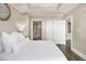 Primary bedroom featuring white bedding and access to the ensuite bathroom and closet at 2277 Peachtree Rd # 503, Atlanta, GA 30309
