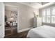 Bedroom boasts dark hardwood floors and a view into the adjacent living area with gallery wall at 2277 Peachtree Rd # 503, Atlanta, GA 30309
