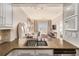 Spacious kitchen with stone counters overlooks comfortable living area with balcony at 2277 Peachtree Rd # 503, Atlanta, GA 30309