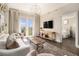 Cozy living room with balcony, modern TV, and open view to bedroom at 2277 Peachtree Rd # 503, Atlanta, GA 30309