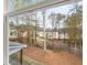 Backyard view featuring a wooden fence, mature trees, and neighboring houses at 2831 Centerville Rosebud Rd, Snellville, GA 30039