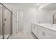 Bathroom with double sink vanity, white cabinets, and glass-enclosed shower at 2831 Centerville Rosebud Rd, Snellville, GA 30039