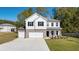 Charming two-story home featuring a brick and siding exterior with a spacious three car garage and well-maintained lawn at 2831 Centerville Rosebud Rd, Snellville, GA 30039