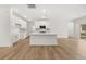 Spacious open-concept kitchen with white cabinets, stainless steel appliances, and an island, seamlessly flowing into living area at 2831 Centerville Rosebud Rd, Snellville, GA 30039