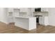Modern kitchen with a central island, stainless steel appliances, and sleek countertops, perfect for cooking and entertaining guests at 2831 Centerville Rosebud Rd, Snellville, GA 30039