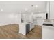 Bright and airy living space featuring an open-concept design, modern kitchen with stainless steel appliances, and hardwood floors at 2831 Centerville Rosebud Rd, Snellville, GA 30039