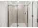 Tiled shower enclosure featuring glass doors and modern fixtures at 2831 Centerville Rosebud Rd, Snellville, GA 30039