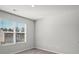 Bedroom with a large window showing great natural light, neutral carpet, and white walls at 3038 Chris Cir, Villa Rica, GA 30180