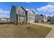 Side view of the two-story house, featuring lawn and driveway at 3038 Chris Cir, Villa Rica, GA 30180