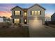 Charming two-story home featuring gray siding, a two-car garage, and manicured landscaping at 3038 Chris Cir, Villa Rica, GA 30180